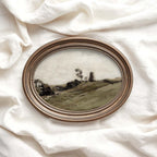 Olive green wall art featuring a pastoral landscape with rolling fields and dark foliage