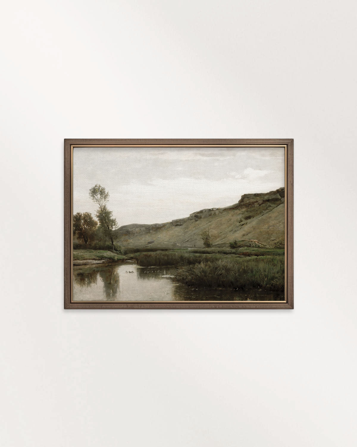 Muted riverside landscape wall art printable with rolling hills, trees and still water