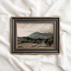 Western landscape art featuring distant mountains, rugged terrain and a soft cloudy sky